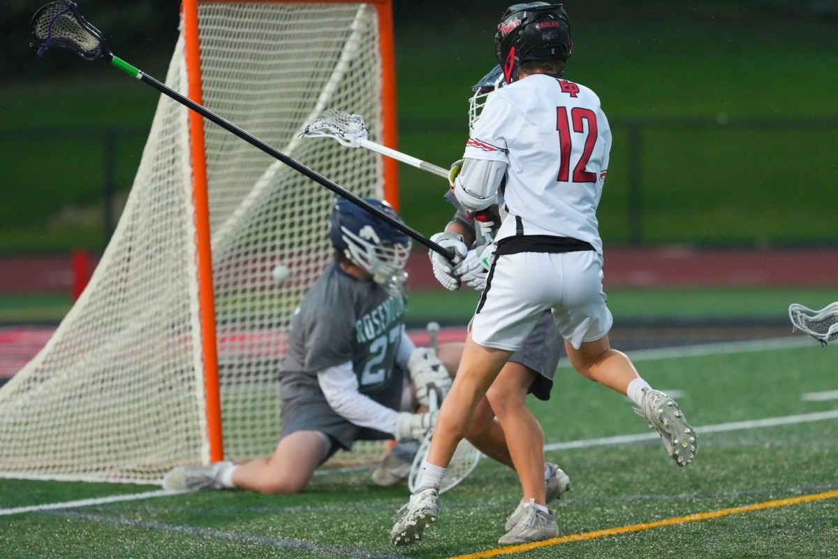 Eden Prairie junior attacker Brady Palmer (12) scores the first of his three goals, helping the Eagles build a 4-0 first-quarter lead en route to a 12-6 Section 6A semifinal win over Rosemount on Monday.