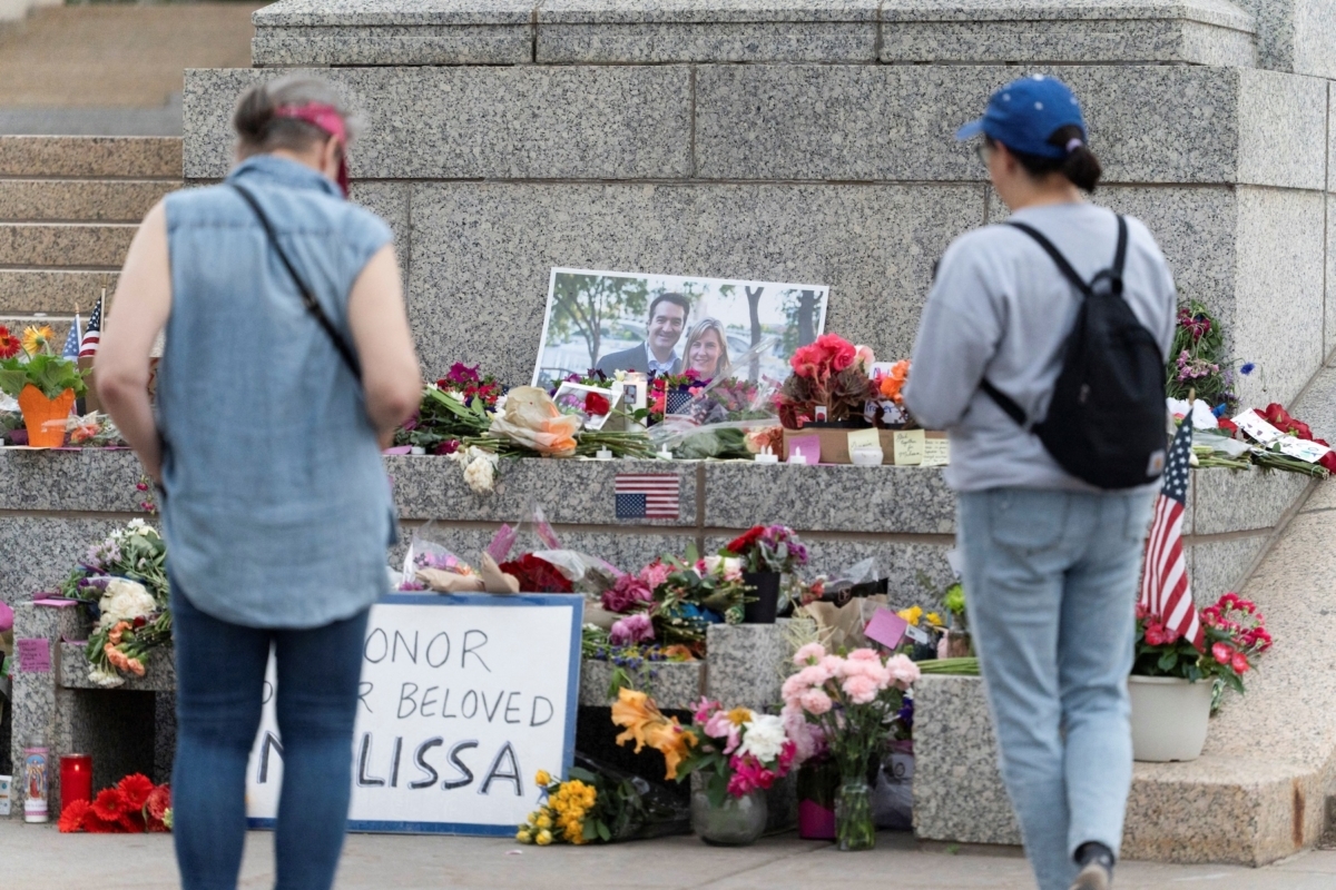 People visit a memorial outside the Minnesota State Capitol in honor of Democratic state assemblywoman Melissa Hortman and her husband Mark, after a gunman killed them, in St. Paul, Minnesota, U.S., June 15, 2025. REUTERS/Tim Evans