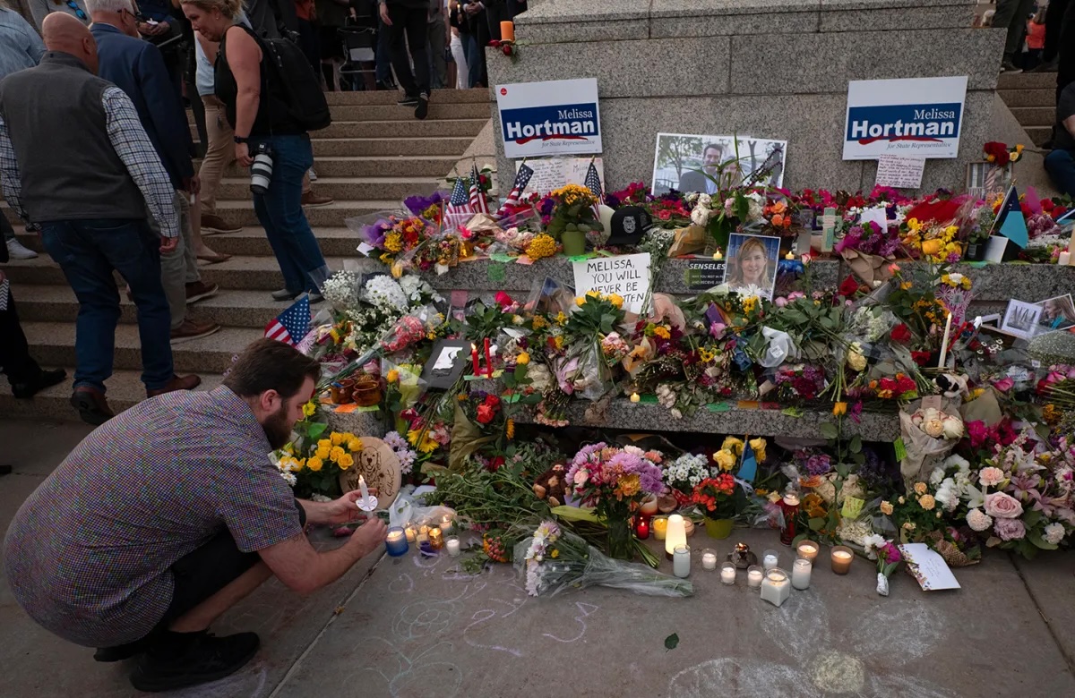 Colin Hortman leaves a candle at the memorial to his mother, Rep. Melissa Hortman, during the candlelight vigil to honor Melissa and Mark Hortman at the Capitol. Both after and before the Hortmans’ deaths, Minnesota lawmakers have feared for their safety.