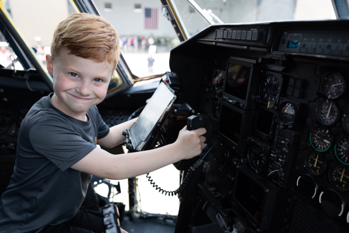 James Hart, 6, of Eden Prairie, sits in the cockpit of a Minnesota National Guard C-130 Hercules during AirFair 2025 at Flying Cloud Airport.