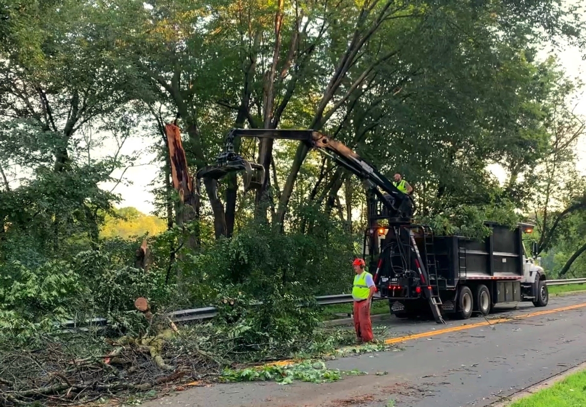 A City tree claw is readied to pick up another bunch of fallen limb
