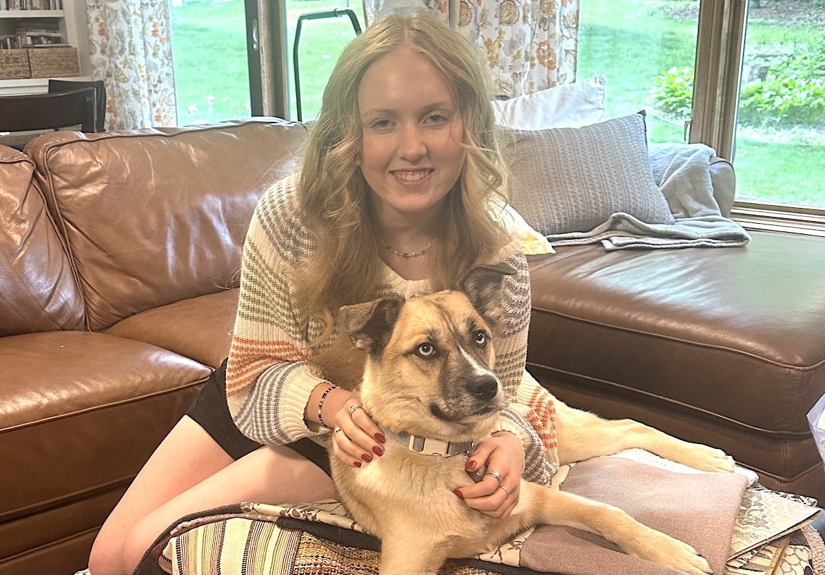 Fiona Rohde and Opal with a few of the dog bed covers that Rohde designed and sewed with donated La-Z-Boy fabric for Warrior Dog Rescue as part of her National Honor Society project. Photo by Lea Jacobson