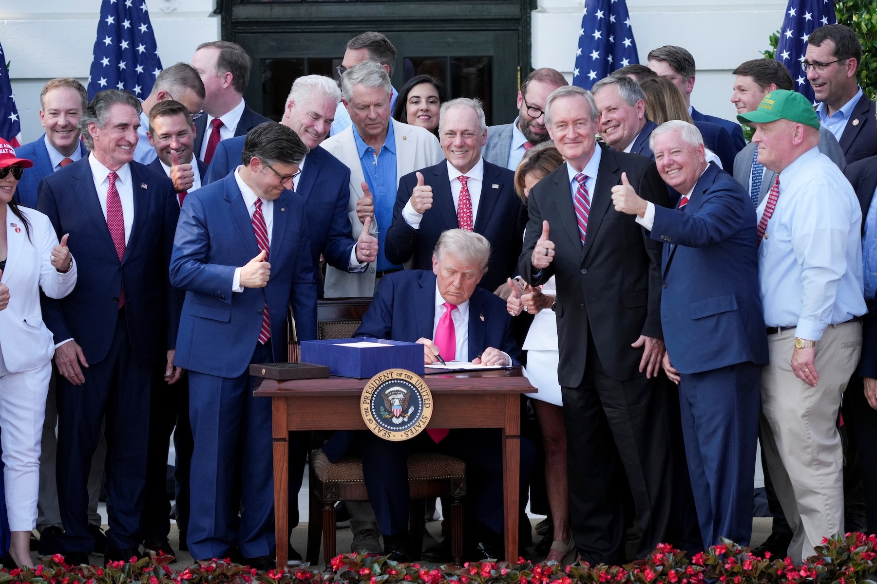 U.S. President Donald Trump signs sweeping spending and tax legislation, known as the “One Big Beautiful Bill Act,” during a picnic with military families to mark Independence Day at the White House in Washington, D.C., on July 4. Photo by REUTERS/Ken Cedeno