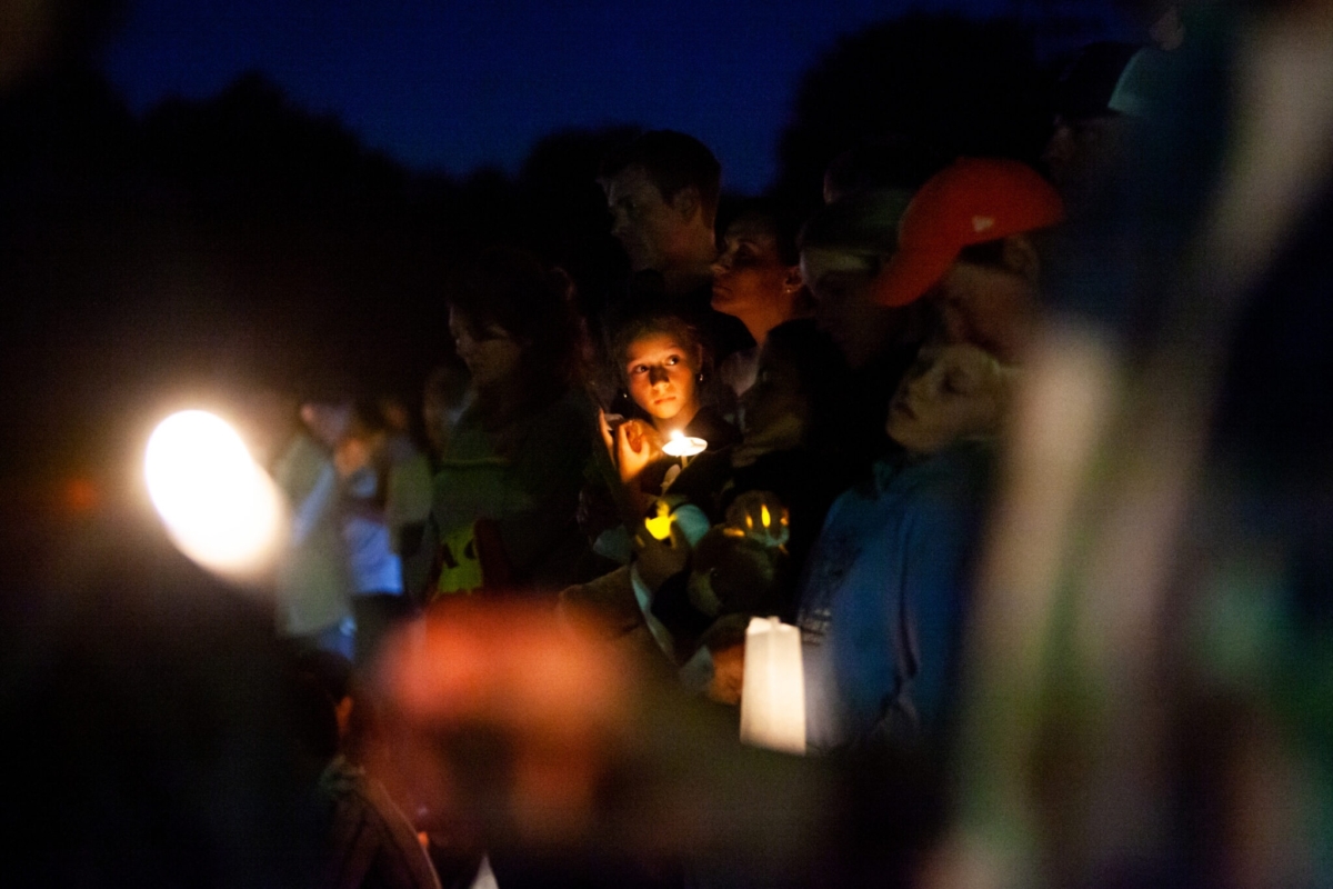 A young girl holds her teddy bear as hundreds gather during a dark and solemn vigil at Lynnhurst Park for the two children who were killed and the several children and parishioners injured in a shooting at Annunciation Church Wednesday, Aug. 27, 2025 in south Minneapolis. (Photo by Nicole Neri/Minnesota Reformer)