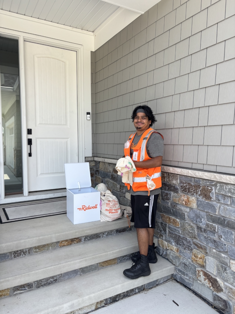 Ridwell employee Ivan Roque collects bags filled with hard-to-recycle items from an Eden Prairie home. Photo by Jody Carey