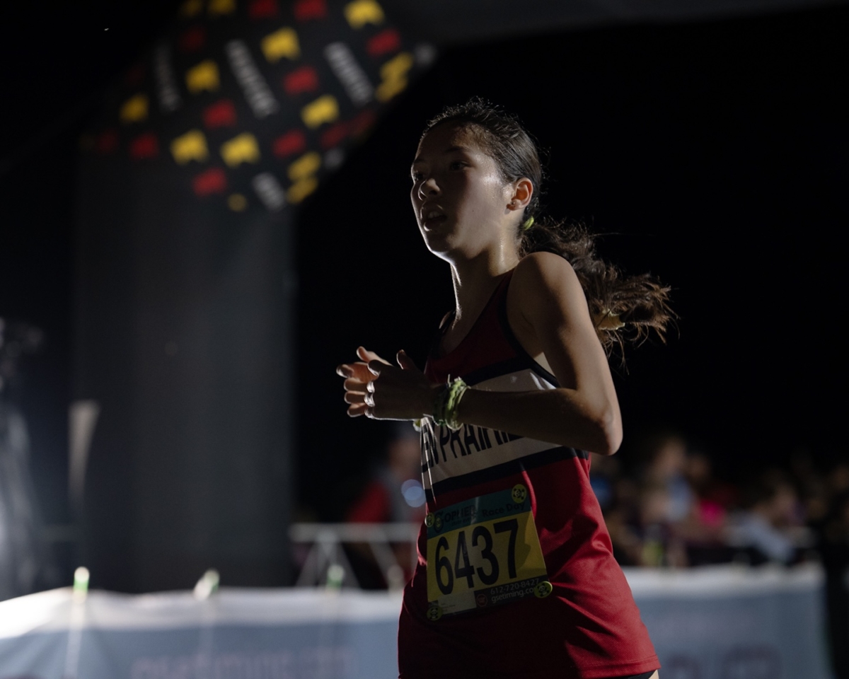 Eden Prairie freshman Winona Nelson competes in the Metro Invitational on Sept. 13 at Flying Cloud Fields. Nelson finished 30th in the varsity girls’ 5,000-meter race at the meet, which featured more than 2,000 runners under the lights.