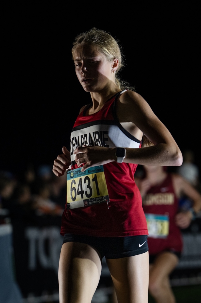 Eden Prairie’s Anna Lang competes in the girls varsity race at the Metro Invitational on Sept. 13 at Flying Cloud Fields. The meet, Minnesota’s largest, featured more than 2,000 runners and races under the lights.