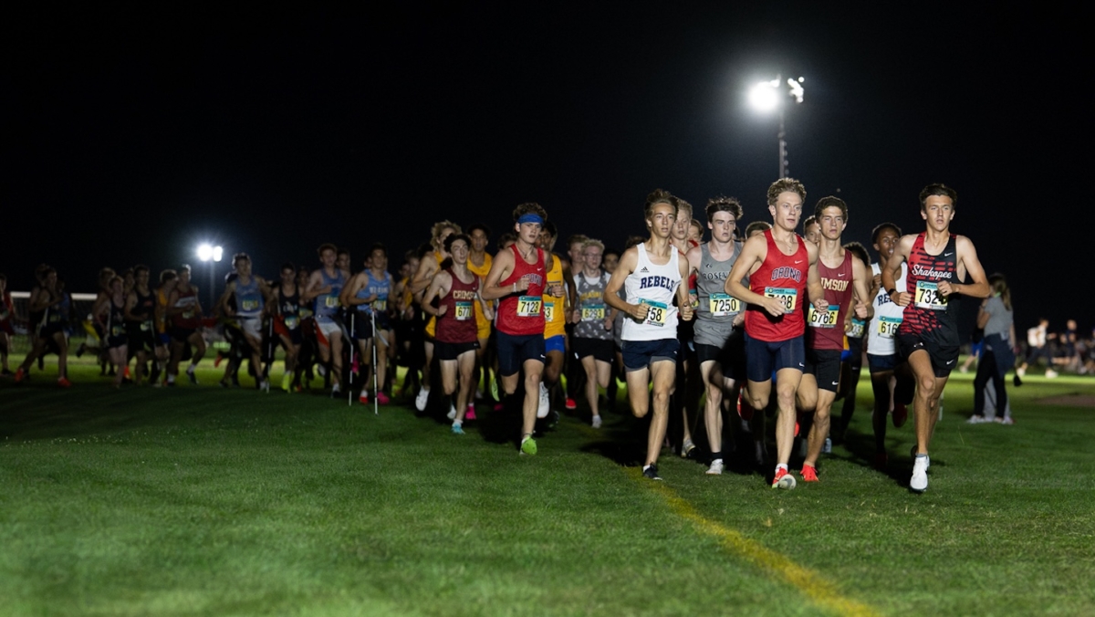 Runners compete under the lights at the Metro Invitational on Sept. 13 at Flying Cloud Fields in Eden Prairie. The annual meet drew more than 2,000 athletes, making it the largest cross country event in Minnesota.