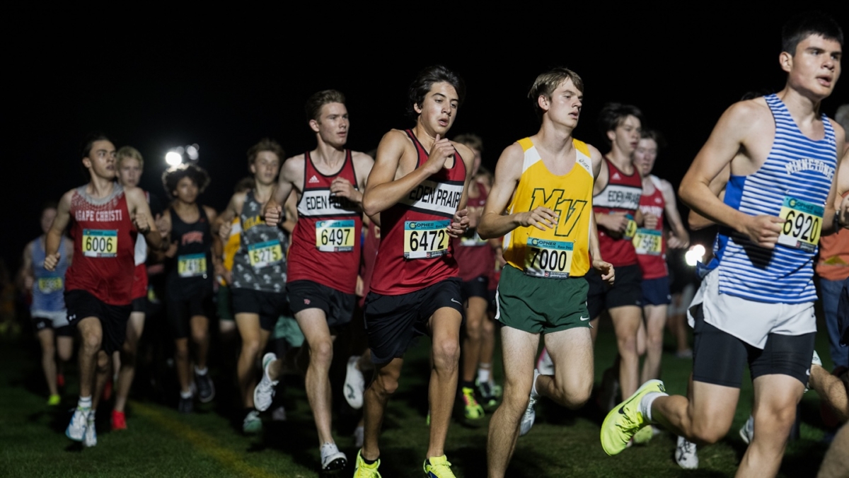 Eden Prairie’s Charles Fosmer (6472), a sophomore, runs ahead of teammate Logan Tyler (6497), a junior, during the Metro Invitational on Sept. 13 at Flying Cloud Fields. The meet drew more than 2,000 athletes for races held under the lights.