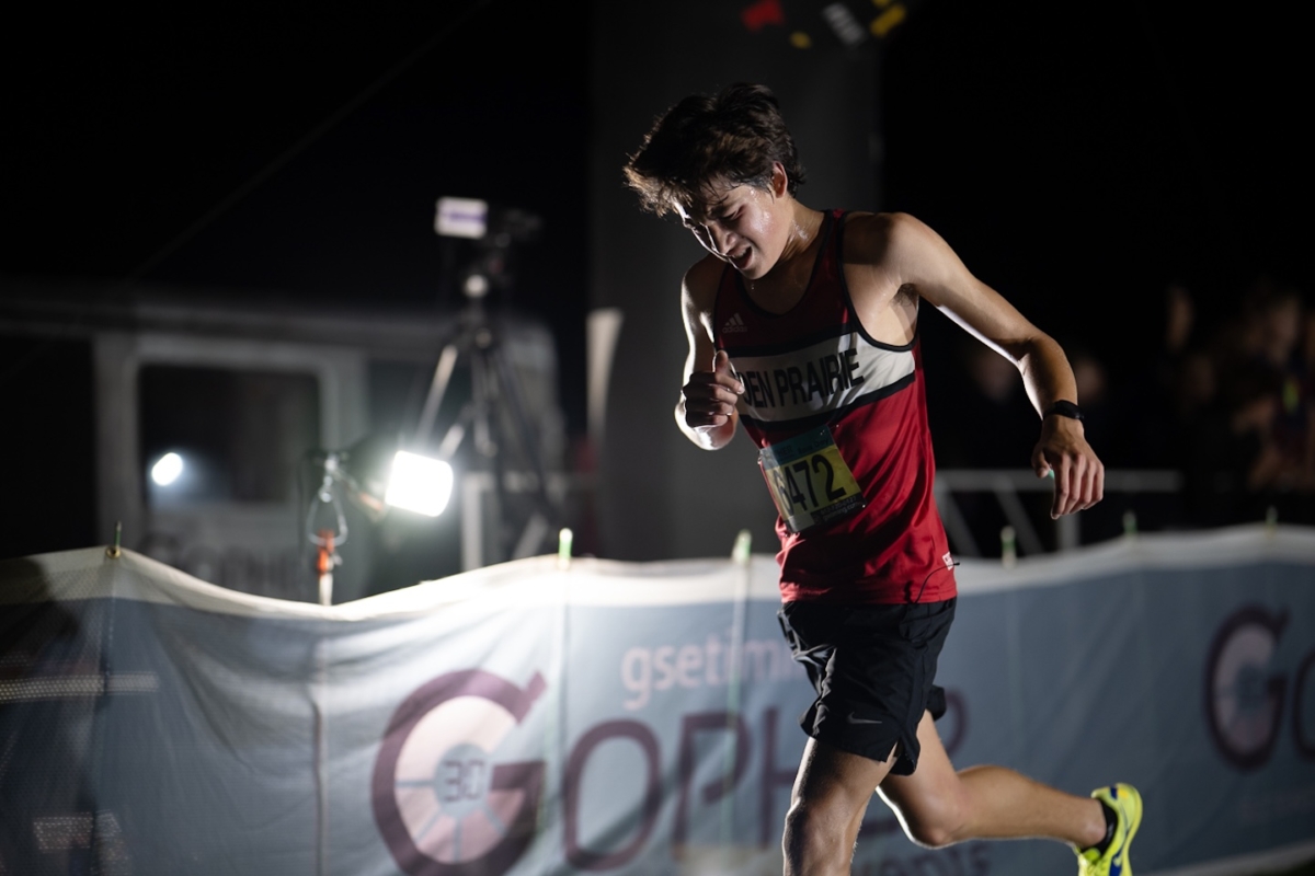 Eden Prairie sophomore Charles Fosmer (6472) runs in the Metro Invitational on Sept. 13 at Flying Cloud Fields. The annual nighttime meet drew more than 2,000 athletes, making it the largest cross country event in Minnesota.