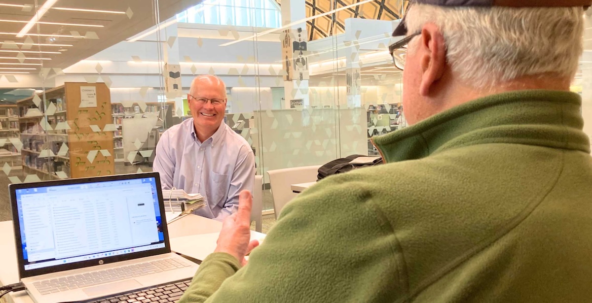 Mark H. Weber, left, listens as Steve Schewe, right, speaks during a Sept. 5 meeting.