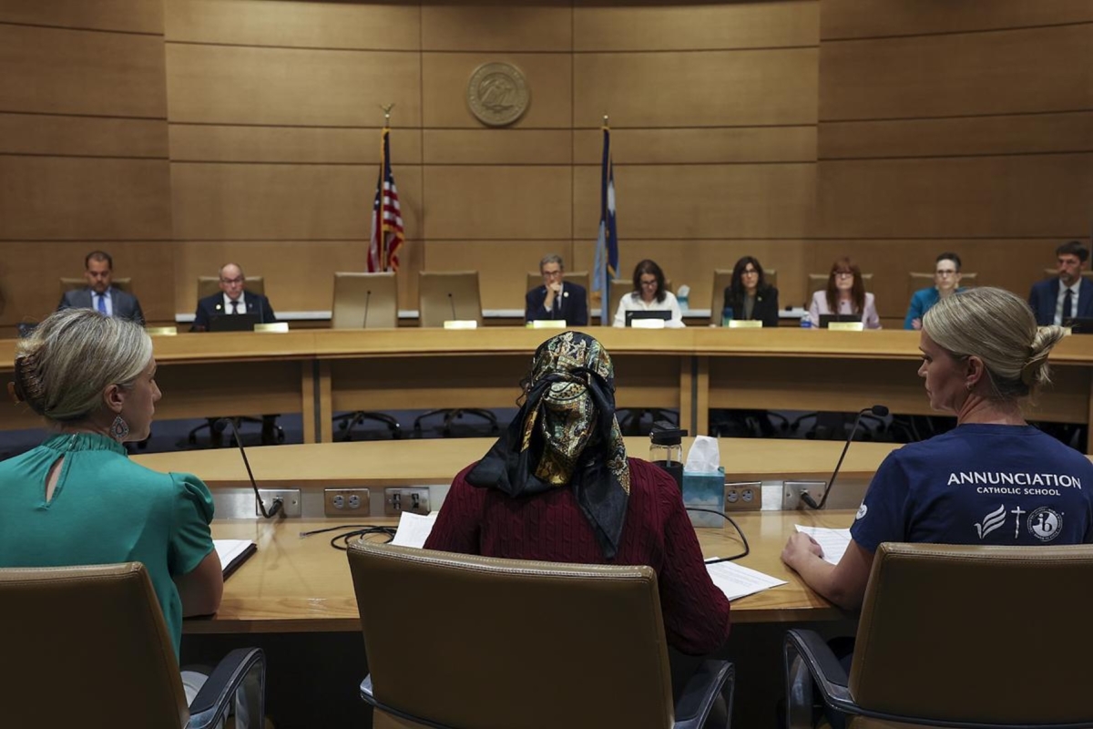 Democratic State Sen. Zaynab Mohamed sits between Annunciation parents Megan Damen, left, and Malia Kimbrell, right, during a meeting of the Gun Violence Prevention Working Group at the Minnesota Senate Building on Monday, Sept. 15, 2025, in St. Paul, Minn. The gathering was the first public meeting to discuss gun reform after the shooting at Annunciation Catholic Church and School. Credit: Ellen Schmidt/MinnPost/CatchLight Local/Report for America