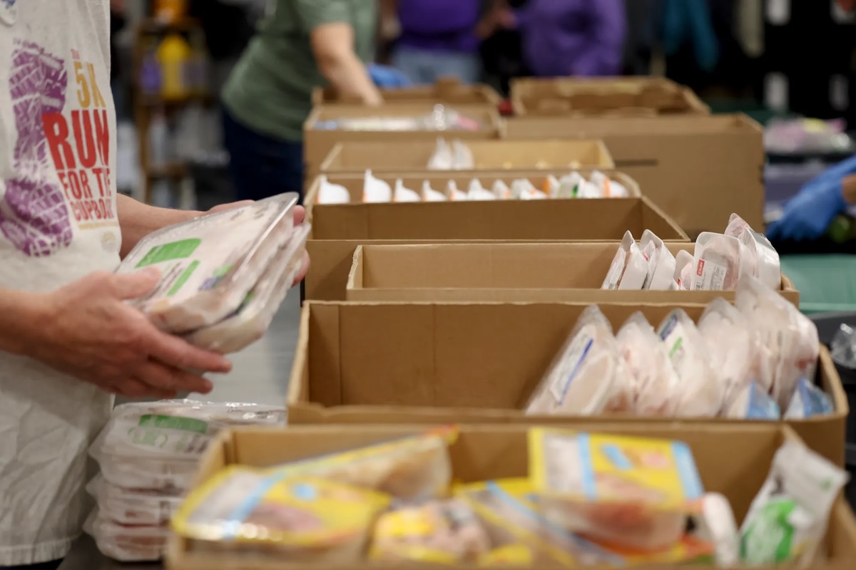 Volunteers sort donated food at The Open Door food pantry on Monday, Oct. 27, 2025, in Eagan, Minn. The Open Door is a hunger relief organization with food pantries across Dakota County. Gov. Tim Walz announced that Minnesota will use $4 million in emergency state funding to fill some gaps at food shelves as SNAP benefits are set to end if the government shutdown continues.