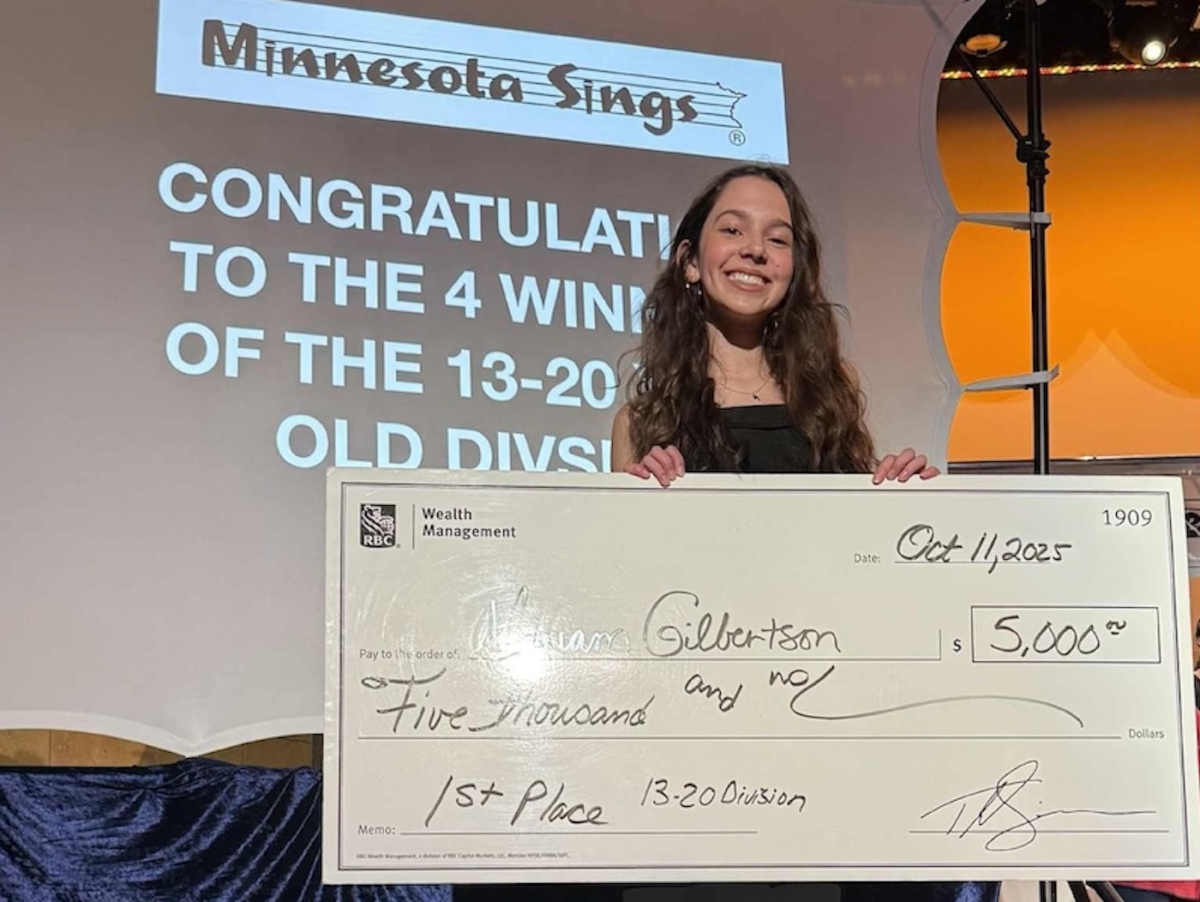 Minnesota Sings champion Miriam Gilbertson, a Chanhassen resident and 2024 Eden Prairie Sings! winner, holds her $5,000 prize check following her first-place finish at the statewide contest in Austin. Photo courtesy of the Eden Prairie Optimist Club