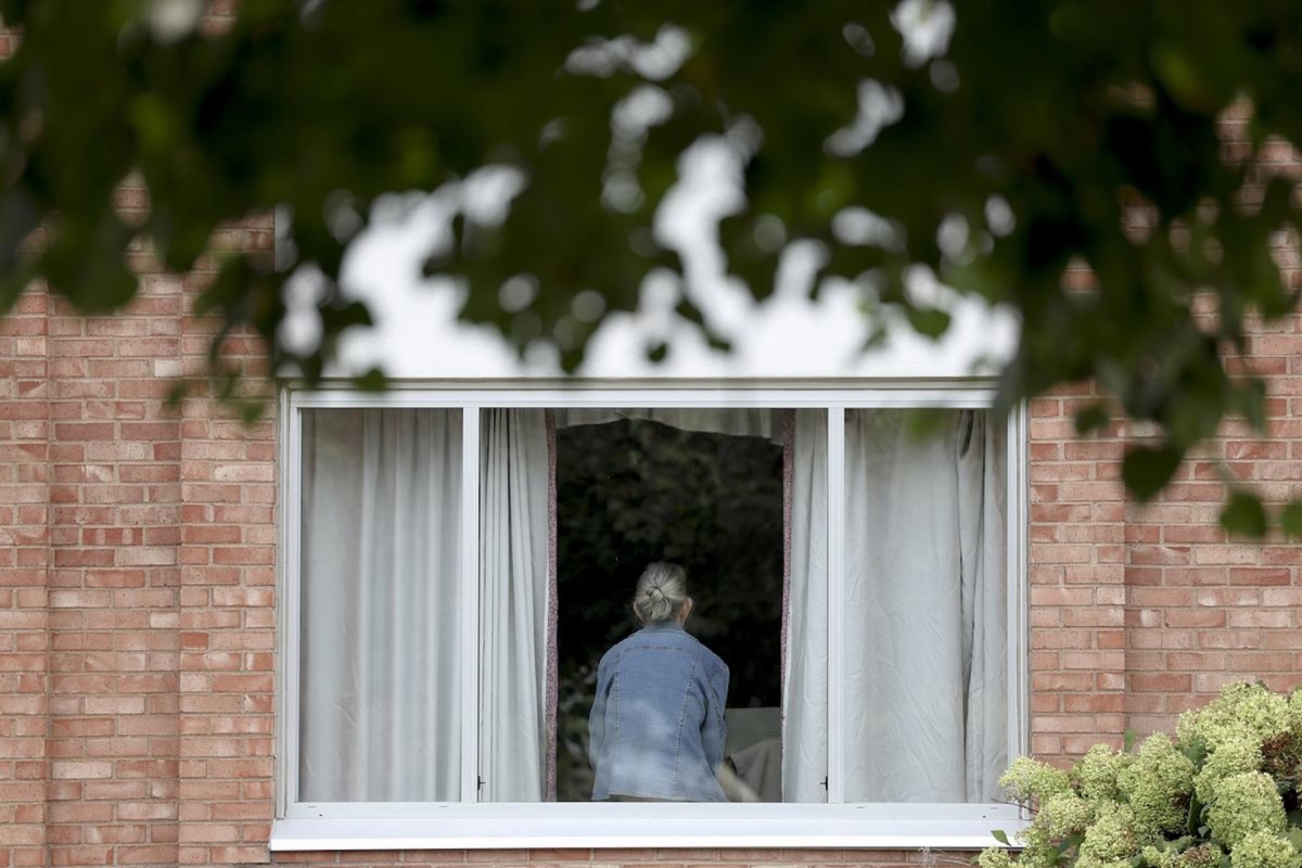 A woman sits on the window sill at the Maplewood Rehabilitation Center on Thursday, Oct. 2, 2025, in Maplewood, Minn.