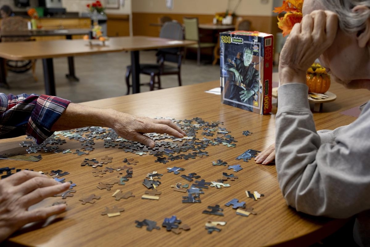 Residents in the memory care unit at the Maplewood Rehabilitation Center work on a puzzle on Tuesday, Sept. 30, 2025, in Maplewood, Minn.