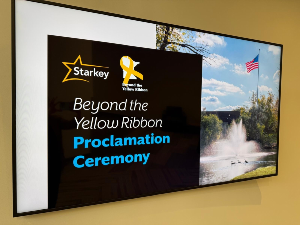 close-up of slide with American flag and fountain on right and Beyond the Yellow Ribbon Proclamation Ceremony on left