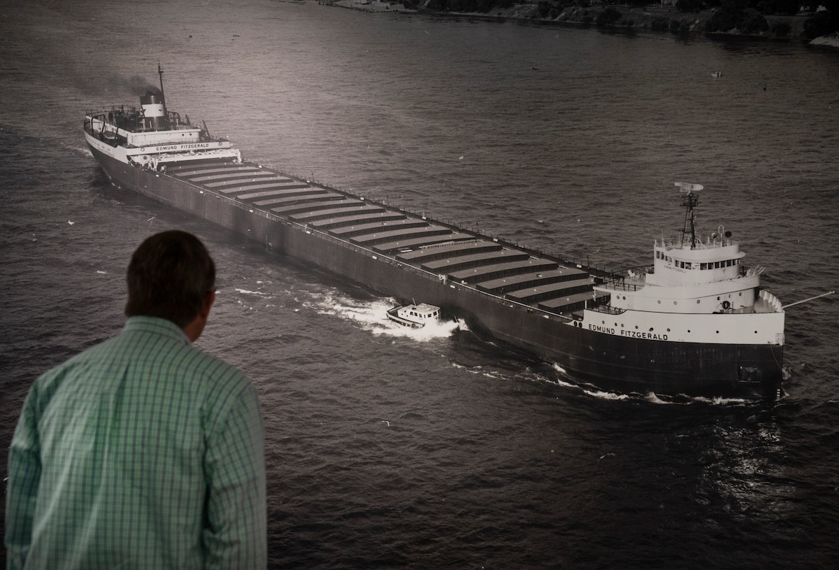 Richard Russell of Grosse Pointe Shores looks at a large photo of the SS Edmund Fitzgerald, which is featured extensively at the Dossin Great Lakes Museum on Belle Isle, on Friday, Oct. 24, 2025. Russell built a scale model of the freighter. (USA TODAY Network via Reuters Connect)