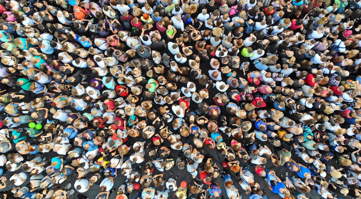 Overhead view of a large crowd symbolizing community, connection, and the shared spirit of belonging.