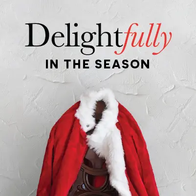 A photo of Santa's red coat hanging on a coat rack.