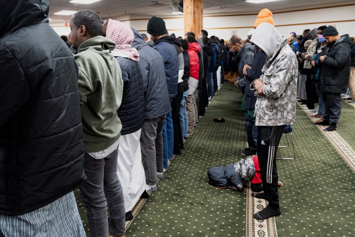 A child bows during Friday Jum’ah prayer at Abubakar As-Saddique Islamic Center amid a reported federal immigration operation targeting the Somali community in Minneapolis on Dec. 5, 2025. Photo by REUTERS/Tim Evans